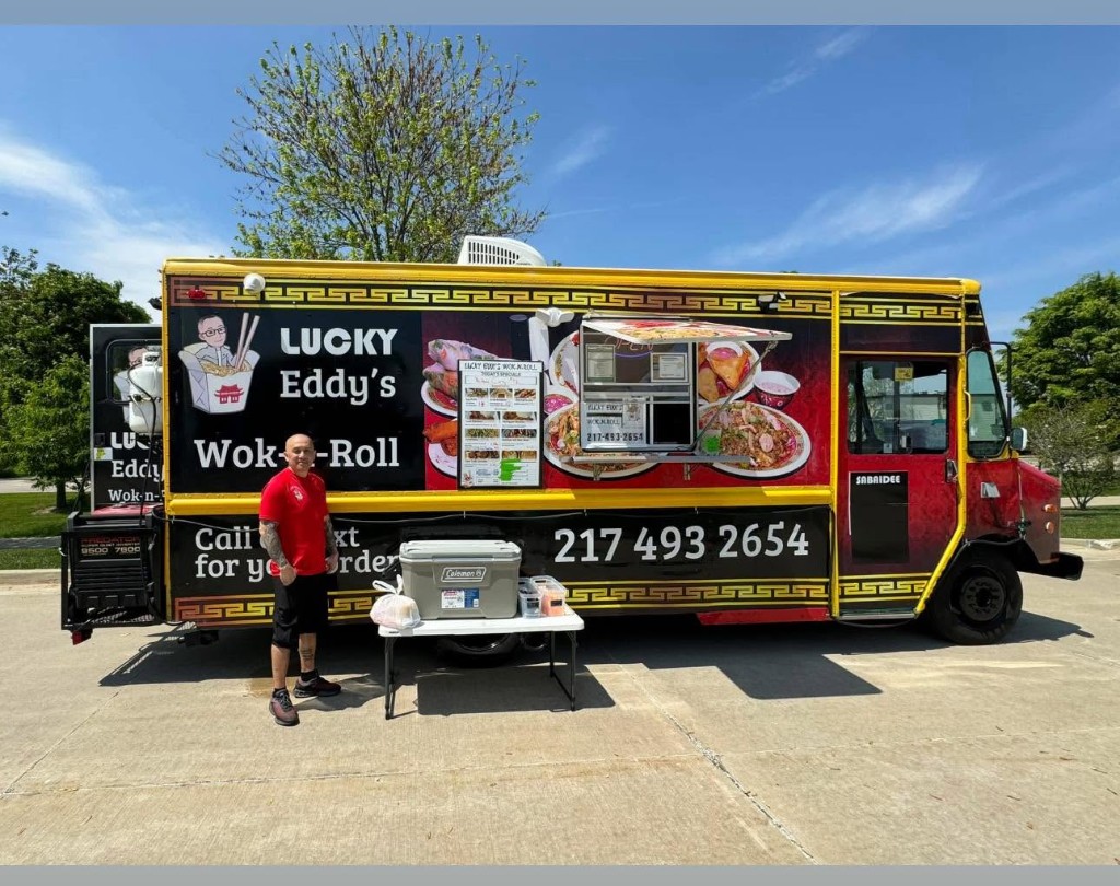 Eddy standing in front of the Lucky Eddy's Wok-n-Roll food truck